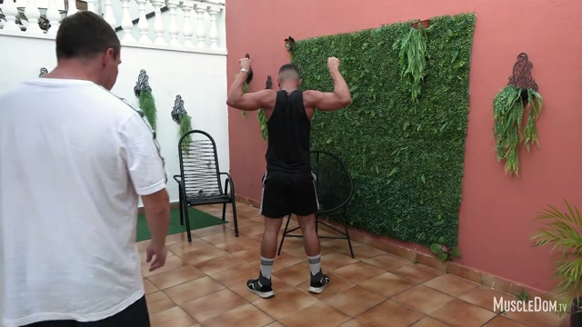 latin stud flexes biceps for muscle worshipper