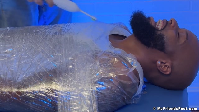 man wrapped in plastic gets size 12 feet tickled