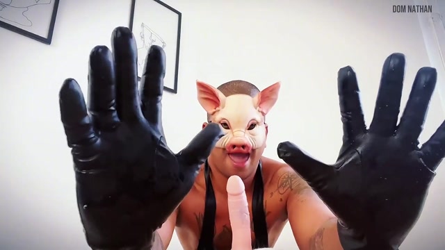 man in pig mask gloves up for dildo play