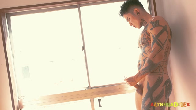 Inked Japanese Stud Wanks Off in Public Window