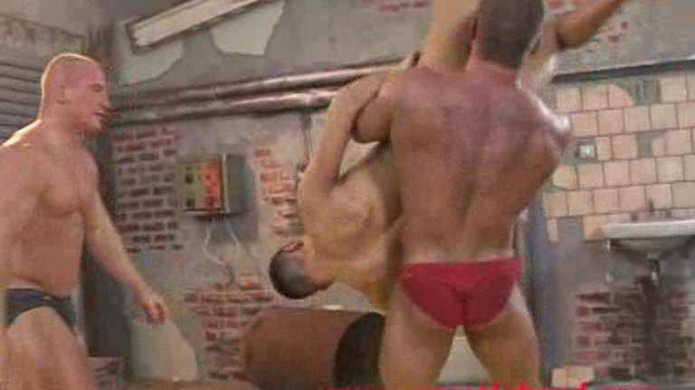 bodybuilders wrestle with twink