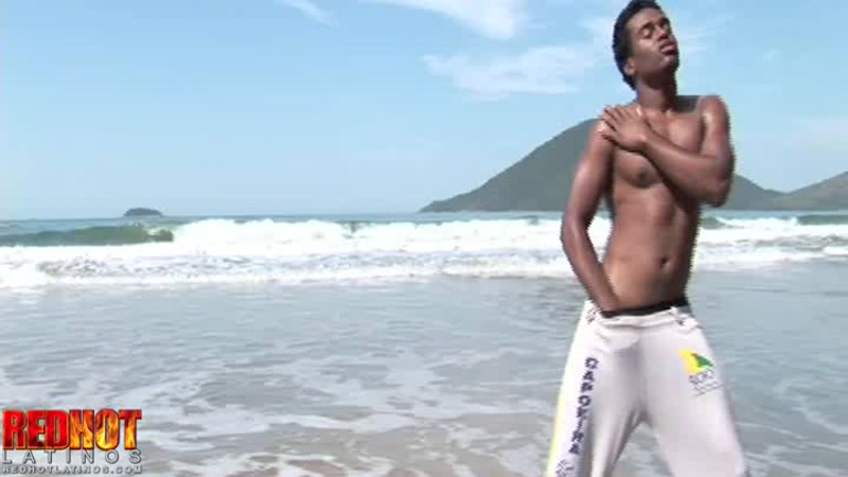 dark-skinned latino is a cock tease on the beach