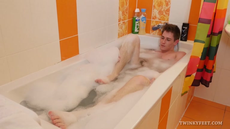 adam soaks in the tub and plays with his feet