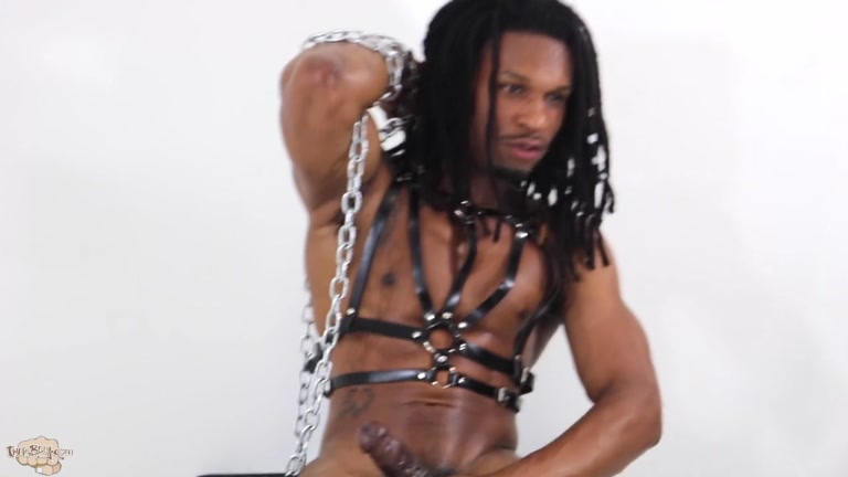 black guy with dreads in leather harness