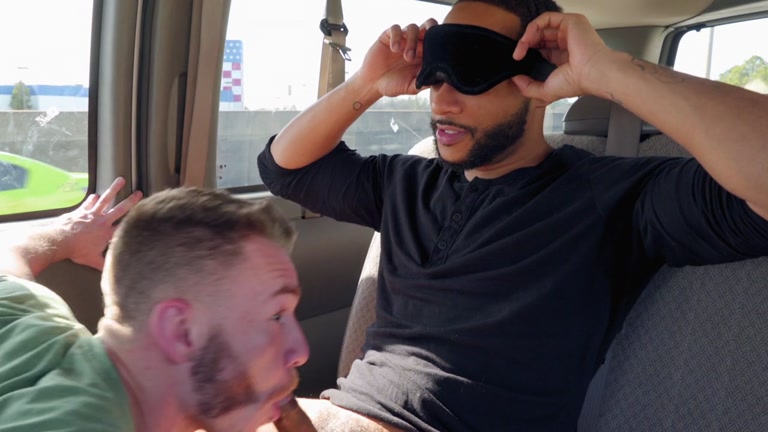 black guy removes blindfold to see a guy sucking his cock