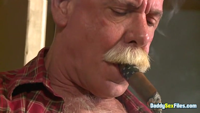 daddy with blond moustache smokes cigar while jacking off