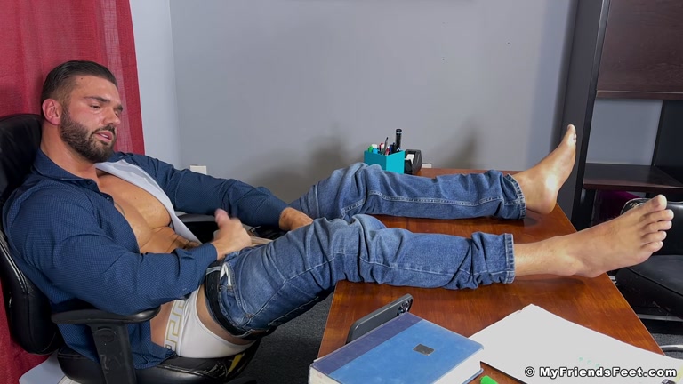 Latino Hunk in Jeans Rests Bare Feet on Desk While Stroking