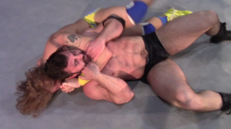 Muscled Wrestler Does Double Bicep Flex While Straddling Opponent