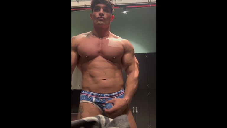 bodybuilder poses in his underwear in locker room