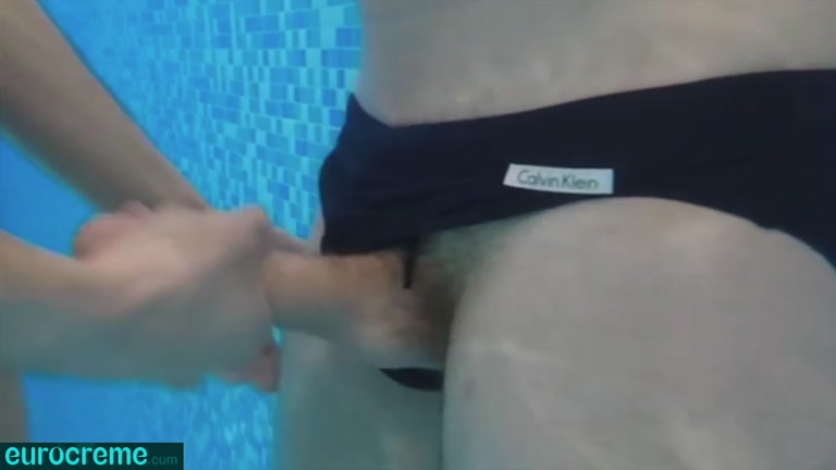 jock gets cock stroked under water in pool