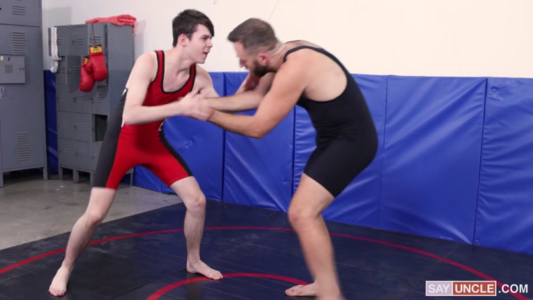 coach massages twink wrestler on mats before fucking him