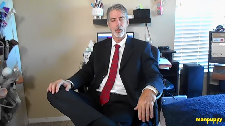 silver fox in suit pulls off his socks in the office