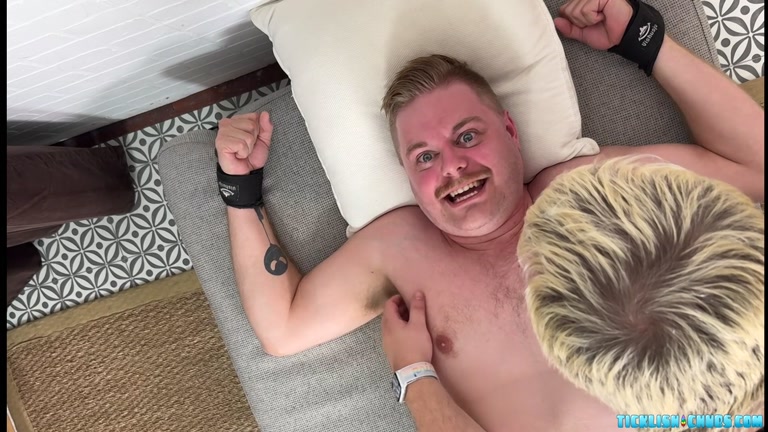 stocky blond laughs loudly while getting tickled