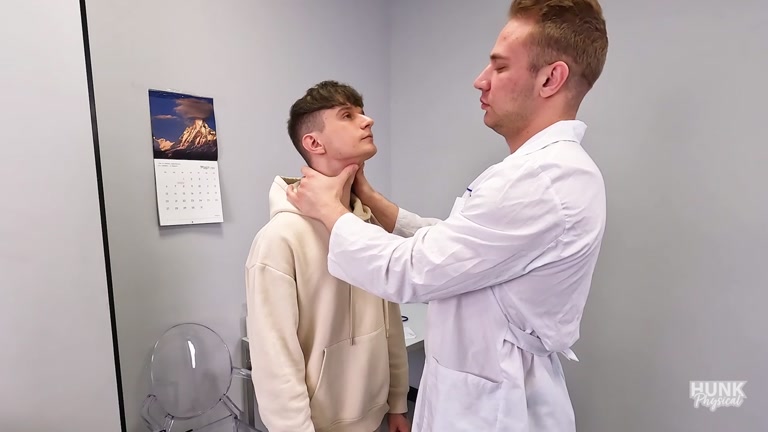 blond doctor gives young patient physical exam