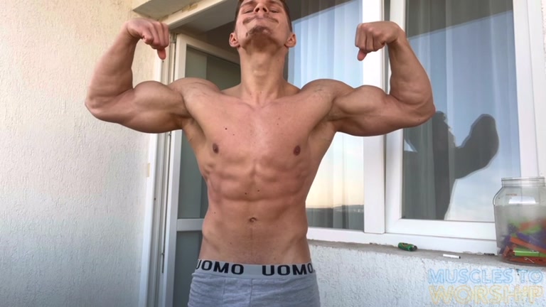 romanian muscle stud flexes his massive biceps