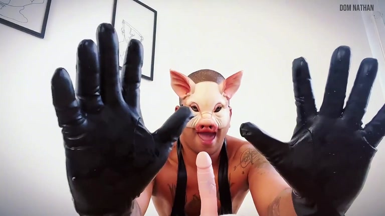 man in pig mask plays with a dildo