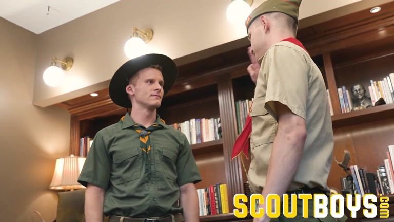 scout leader kisses young lad during his pin ceremony