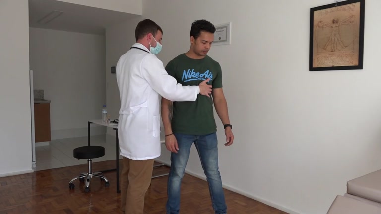 doctor gives athlete yearly sports physical examination