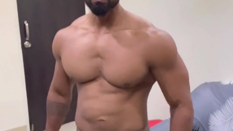 chiseled bearded man shows off his perfect body