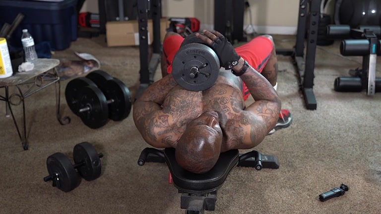 sexy black muscle stud works out with weights