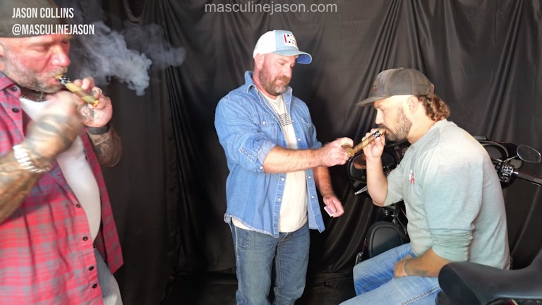 Three Bikers Sitting Around a Harley Smoking Cigars