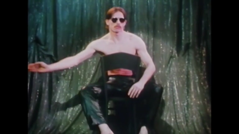 Man with A Moustache Does Strip Tease in Empty Room